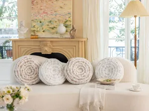 Round decorative throw pillows with tree ring texture in gold and silver, ideal for sofa.
