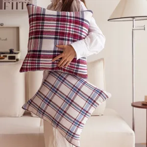 Plaid cushion cover detail showing soft fabric texture and classic grid pattern design.