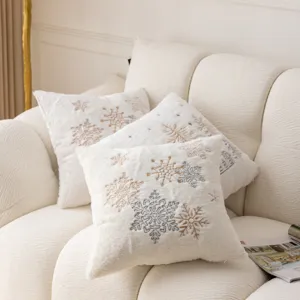 White plush Christmas throw pillow cover with elegant snowflake embroidery for cozy sofa decor.