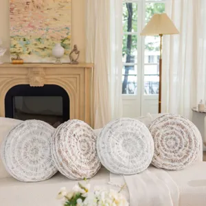 Detailed scene of round textured throw pillows with gold and silver accents on a cozy couch.
