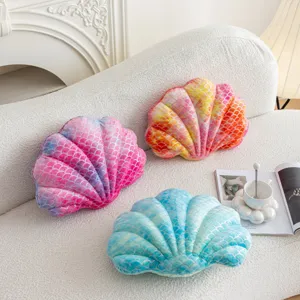 Soft gradient shell shaped plush throw pillow for cozy sofa and bed decor detail view.