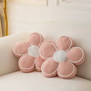 Plush flower pillow detail showcasing soft sherpa fleece fabric, pink petals and white center.