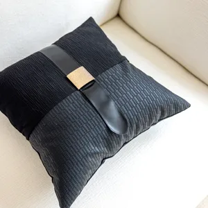 Modern black decorative throw pillow with leather strap and golden buckle for sofa