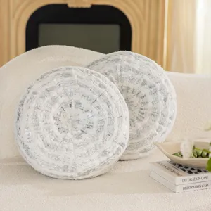 Detail view of round fluffy decorative throw pillow with silver tree ring texture for cozy home.