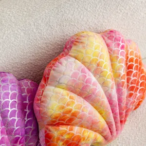 Soft seashell plush pillow with gradient colors and glitter scale texture, cozy home decor cushion.