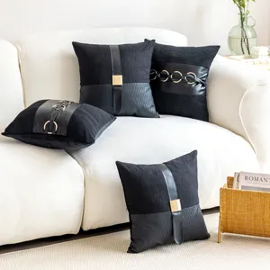 Black leather throw pillow cover with metal ring accent for chic living room sofa decor.