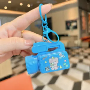 Blue camera projector keychain detail showing cute bear cartoon design and ring.