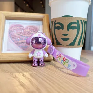 Cute astronaut puppy keychain with purple strap, trendy cartoon bag pendant accessory.