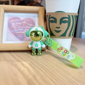 Close-up detail of the green astronaut puppy keychain, trendy bag charm pendant accessory.