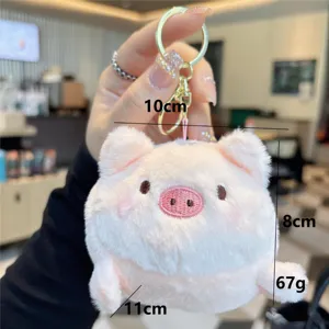 Close-up detail shot of a cute pink plush pig keychain, soft toy with delicate embroidery.