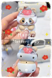Details of the cute glowing panda keychain pendant with transparent heart dome and keyring.
