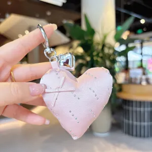 Pink satin heart keychain with rhinestones and bow charm, cute bag pendant accessory.