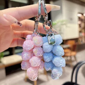 Detailed close-up of a creative dual-color beaded keychain featuring shiny candy-like charms.
