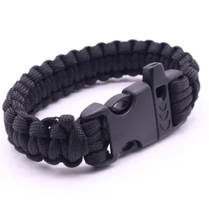 Black paracord survival bracelet with whistle buckle, durable seven-core weave detail.