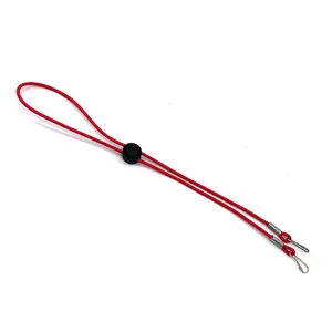Close-up of red elastic mask lanyard with adjustable buckle and metal hooks for daily use.