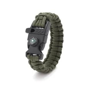 Closeup of the tactical survival paracord bracelet showing integrated compass and whistle.