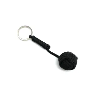 Black paracord monkey fist keychain, durable nylon survival rope lanyard and metal ring.