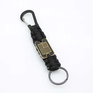 Black paracord keychain with metal carabiner, keyring, and a detailed US flag plaque.