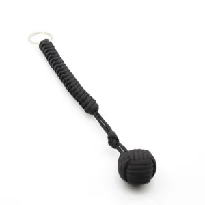 Porte-clés poing de singe en paracorde noire avec boule en acier, pendentif de survie extérieur.