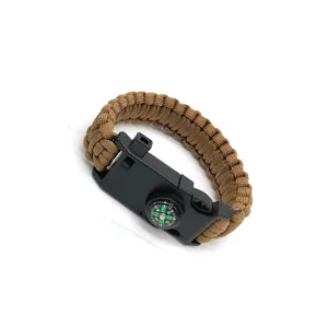 Outdoor survival paracord bracelet with compass and plastic buckle, rugged tactical gear for hiking.