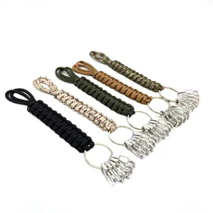 Paracord keychain detail showing hand-woven survival rope with metal carabiners and rings.