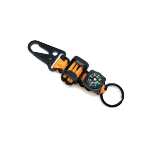 Paracord keychain detail showing orange black woven rope, eagle hook and mini outdoor compass.