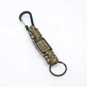 Handmade tactical paracord keychain with metal carabiner and flag plaque for outdoor camping.