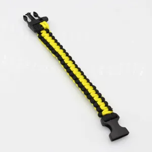 Outdoor survival paracord bracelet with black and yellow woven design and plastic buckle.