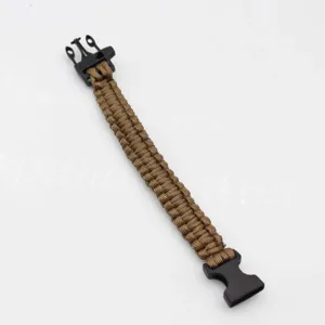 Detailed view of the brown paracord survival bracelet with durable black plastic buckle.