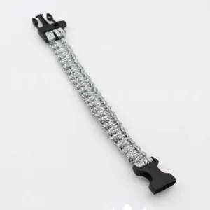 Survival paracord bracelet with plastic buckle, durable outdoor tactical survival tool detail.