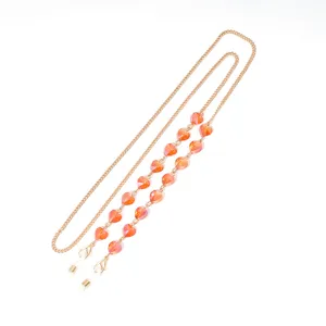 Gold metal glasses chain detailed with orange heart crystals, stylish face mask holder strap.