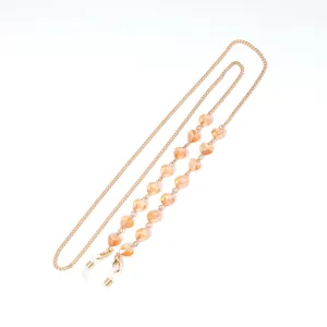 Details of gold crystal eyeglass chain with peach heart beads, elegant mask lanyard holder.