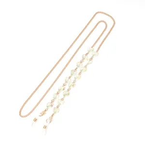 Detail view of a stylish gold metal glasses chain featuring lovely heart crystal beads and silicone loops.