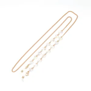 Detailed view of the gold-toned metal chain featuring clear faceted heart beads and loops.
