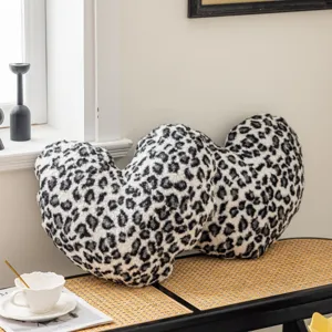 Close up of the soft plush heart shaped leopard print decorative pillow detail and texture.