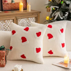 Christmas embroidered throw pillow cover, plush beige sofa cushion with red Santa hat pattern.
