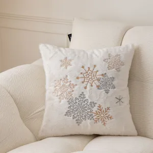 White plush throw pillow cover with elegant embroidered snowflakes for cozy winter home sofa decor.