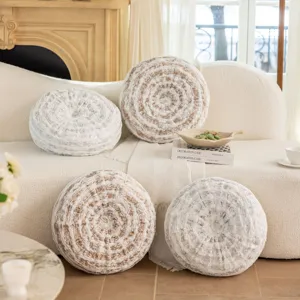 Detailed view of round decorative wheel pillows for sofa and bed in gold and silver tree ring patterns.