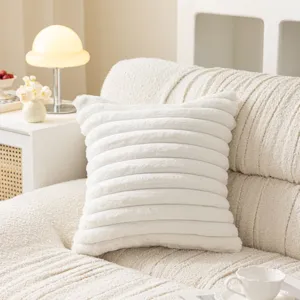 Cozy white plush throw pillow cover, soft textured sofa cushion for living room decor.