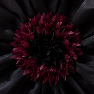 Detailed shot of 3d flower cushion cover, exquisite layered petals texture and dark tone.