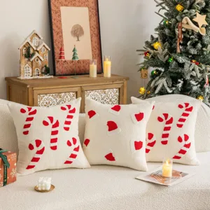 Detailed view of the Christmas embroidered throw pillow featuring cute candy cane and hat designs.