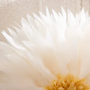 Close-up detail of 3D white lotus petal cushion cover, soft fabric layers with yellow center.