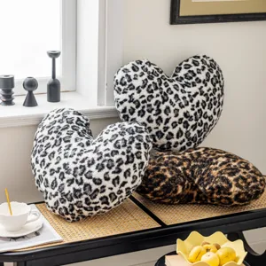 Detailed view of the fluffy heart-shaped leopard print pillow showcasing soft plush texture.