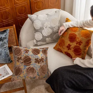 Detailed view of textured velvet pumpkin pattern pillow cover for cozy home decor setup.
