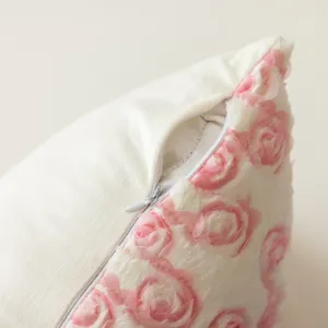 Detailed view of cream plush pillow cover with 3d pink chiffon roses and hidden zipper.