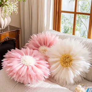 Detailed view of 3D lotus flower throw pillows, soft pink and white floral cushions for sofa.