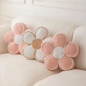 Detail shot of plush flower-shaped cushion, soft cozy home decor pillow for sofa or bedroom.