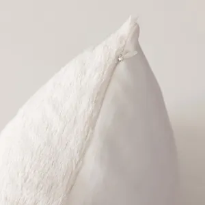 Close-up view of a soft plush pillowcase featuring a hidden zipper and dual-textured fabric.