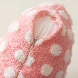 Pink fluffy decorative pillowcase detail, soft plush cushion cover texture zipper.