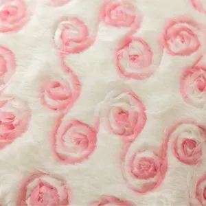 Close up view of fluffy white plush pillowcase featuring delicate 3D pink fabric rose details.